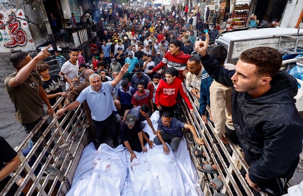 Mourners gather around the bodies of members of the Abu Dalal family, who were killed in an Israeli strike on their home, in Nuseirat, central Gaza Strip. (Reuters)