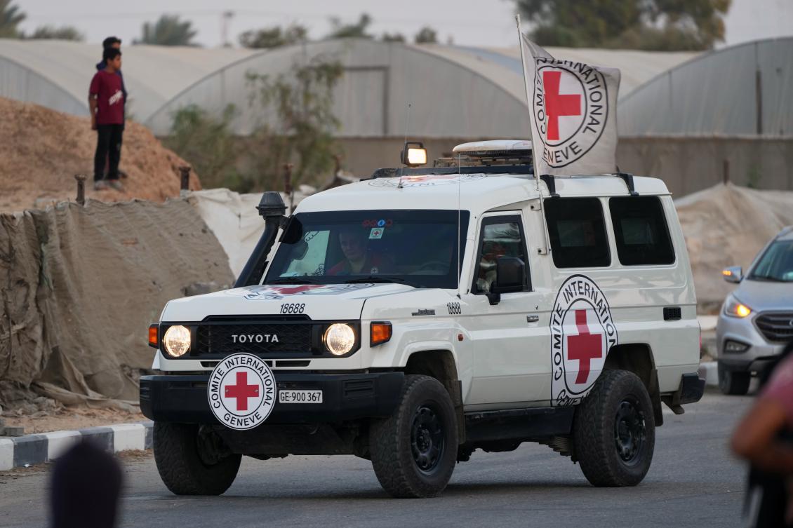A Red Cross vehicle part of a convoy carrying the bodies of two people believed to be deceased hostages handed over by Hamas make their way toward the Kissufim border crossing with Israel. (AP)