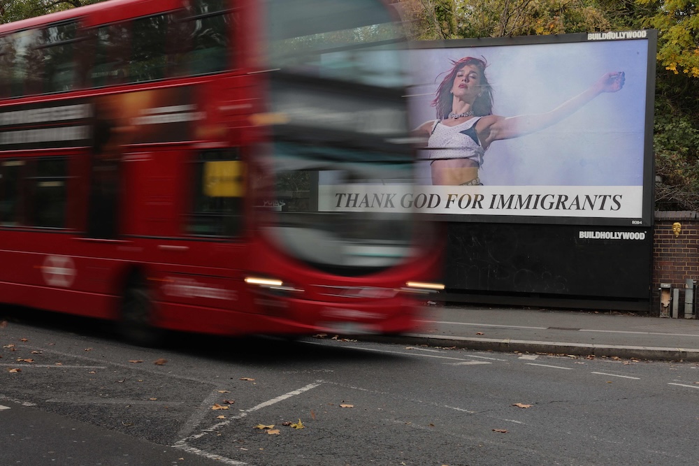 Above, a London bus drives past a ‘Thank God for immigrants’ billboard on Oct. 30, 2025. (AFP)