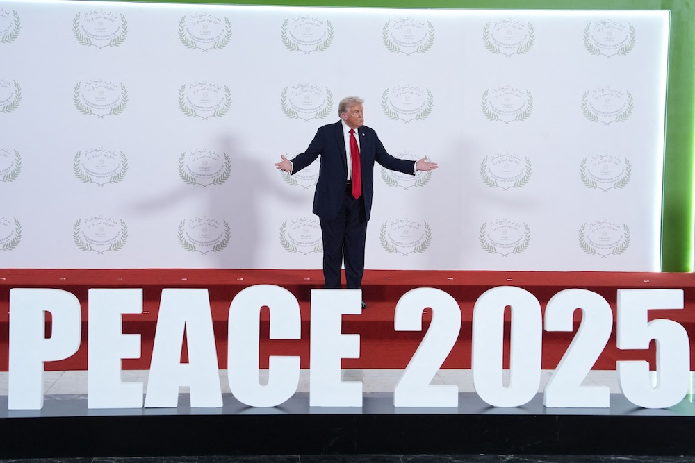US President Donald Trump waits to greet leaders during a summit on Gaza in Sharm El-Sheikh on Oct. 13, 2025. (AFP)