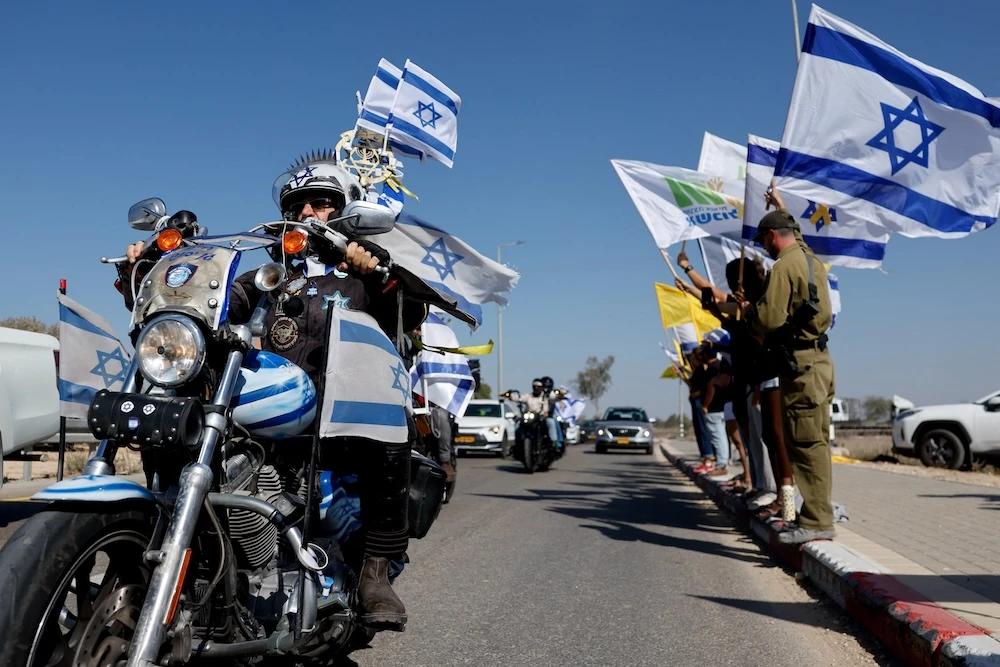 Above, mourners during a funeral procession for Israeli hostage Yossi Sharabi at Kibbutz Beeri, Israel. (Reuters)