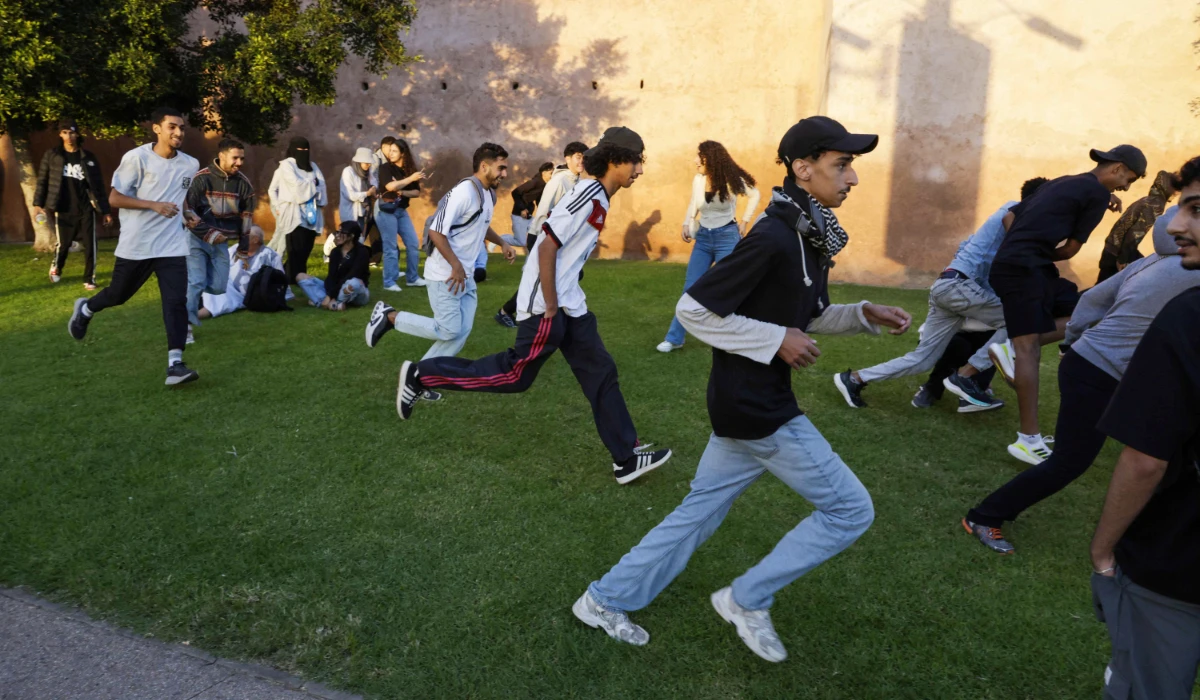 Protesters flee as members of the security forces disperse them during a youth-led demonstration in Rabat on September 29, 2025, calling for reforms in the public health and education sectors. (AFP)