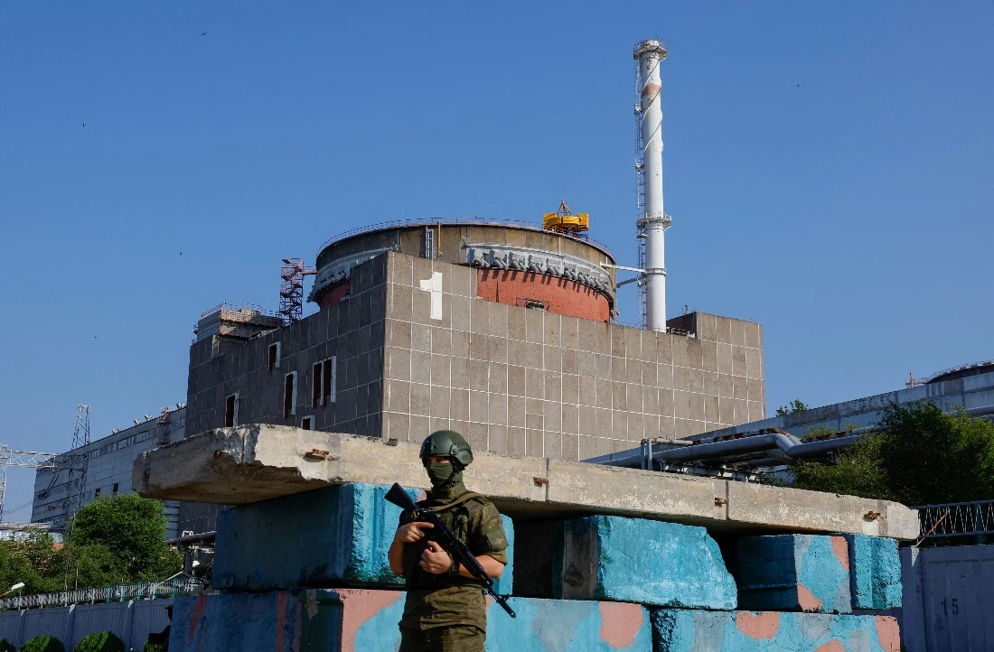 A Russian service member stands guard at a checkpoint near the Zaporizhzhia Nuclear Power Plant. (Reuters)