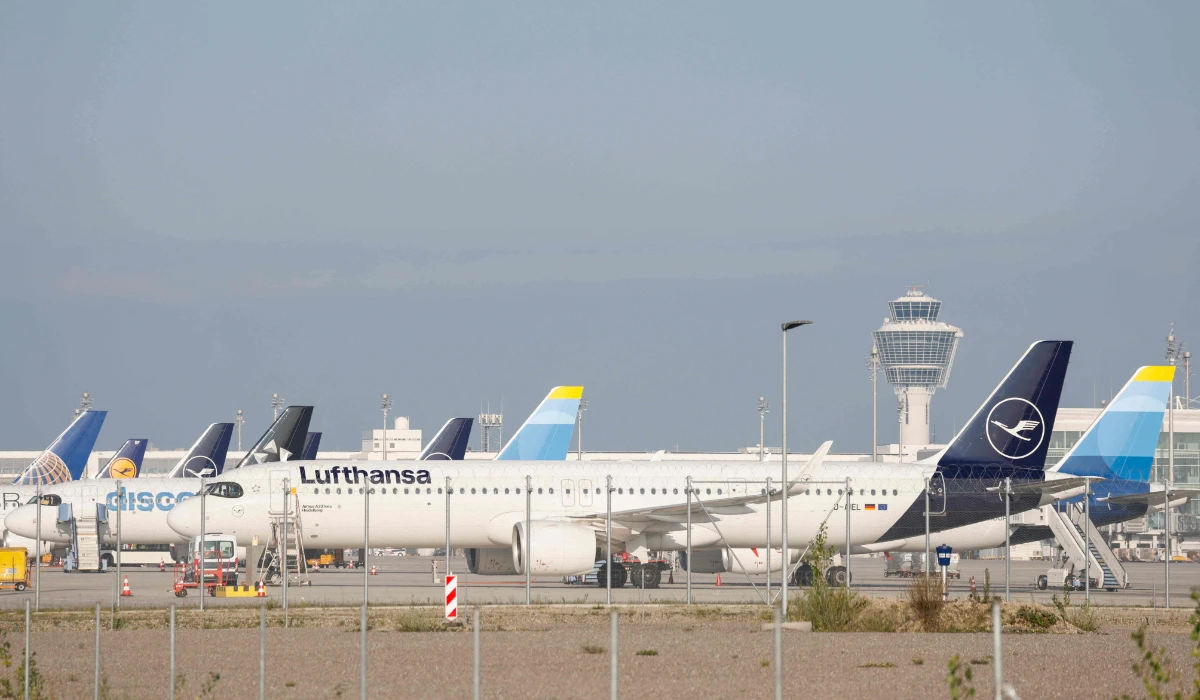 Planes of German airline Discover (R) and Lufthansa (2nd R) are grounded at Munich International Airport in Munich, southern Germany, on August 27, 2024, during a strike of flight attendants and pilots. (AFP)