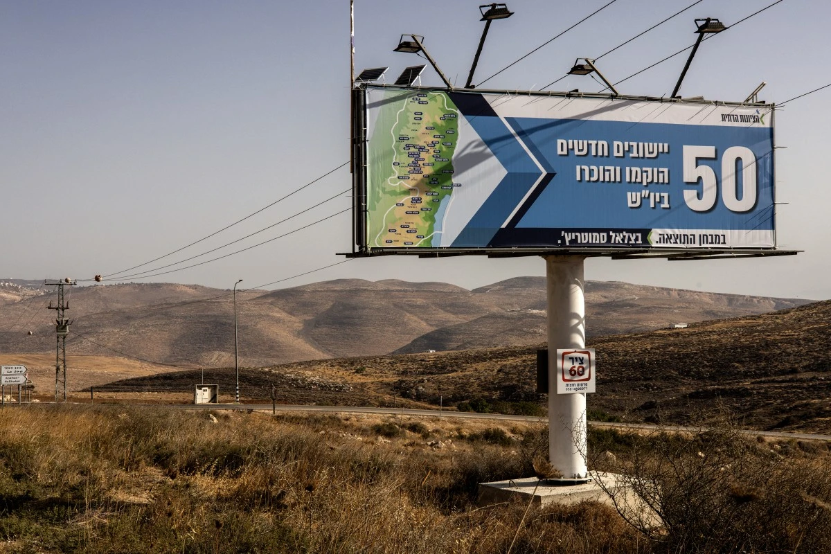 A billboard stating “50 new settlements have been recognised” is pictured outside the Israeli settlement of Kohav HaShahar in the north of the occupied West Bank, Sept. 22, 2025. (AFP)