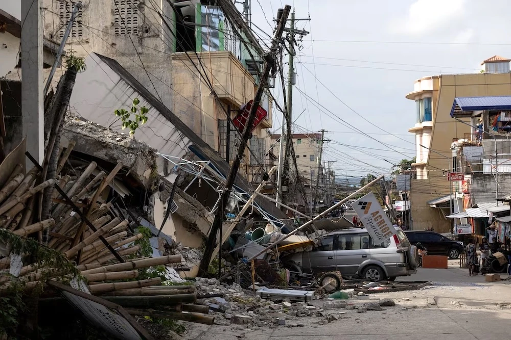 A vehicle partially buried under rubble amid destruction caused by the magnitude 6.9 quake in Bogo, Cebu, Philippines, Oct. 2, 2025. (Reuters)