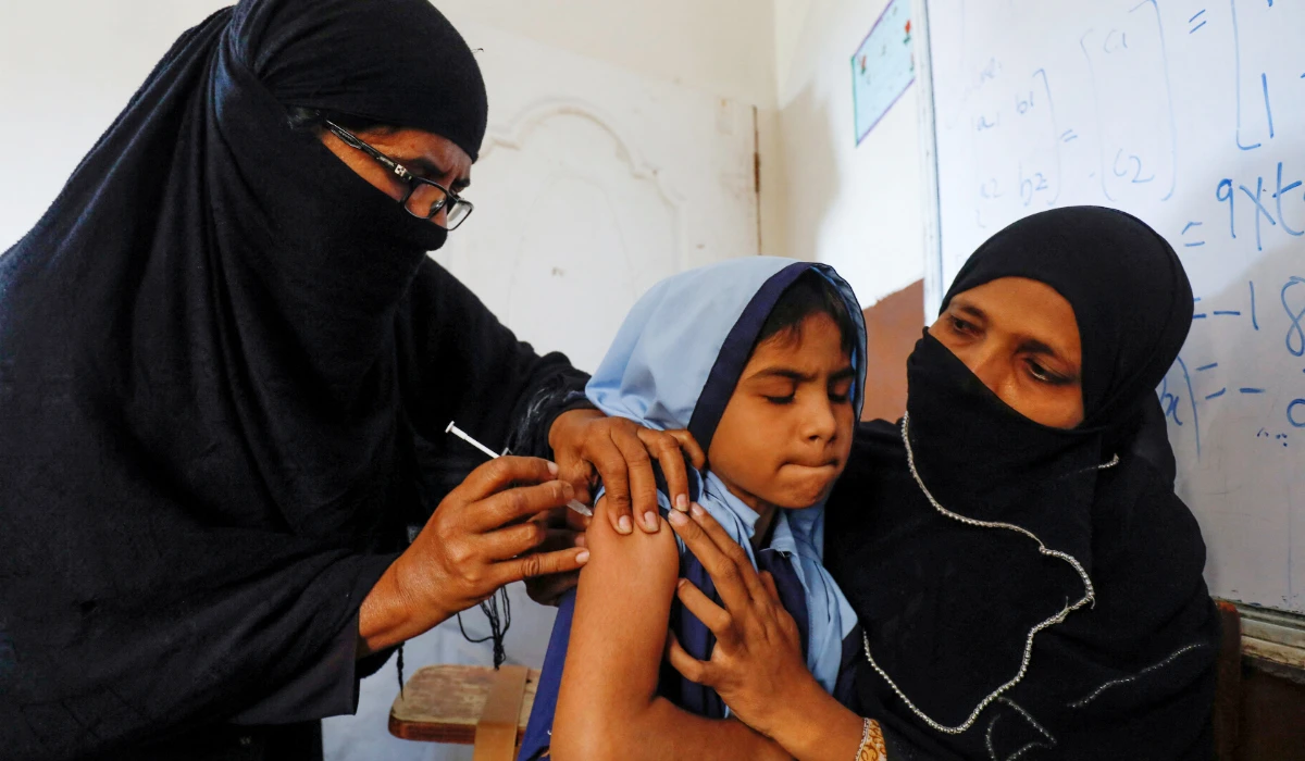 A student reacts as she gets a free anti-typhoid vaccine during the immunisation campaign at a school in Karachi, Pakistan November 20, 2019. (REUTERS)