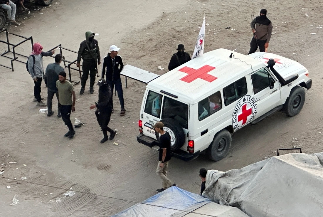 A Red Cross vehicle moves along a road before the expected release of hostages held in Gaza as part of a ceasefire and hostages-prisoners swap deal between Hamas and Israel, in Khan Younis, southern Gaza Strip. (Reuters)