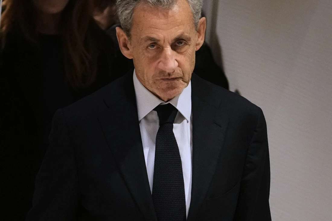 Former French President Nicolas Sarkozy leaves after a Paris court sentenced him to 5 years after finding him guilty of criminal conspiracy in an alleged scheme to finance his 2007 campaign with funds from Libya. (AP)