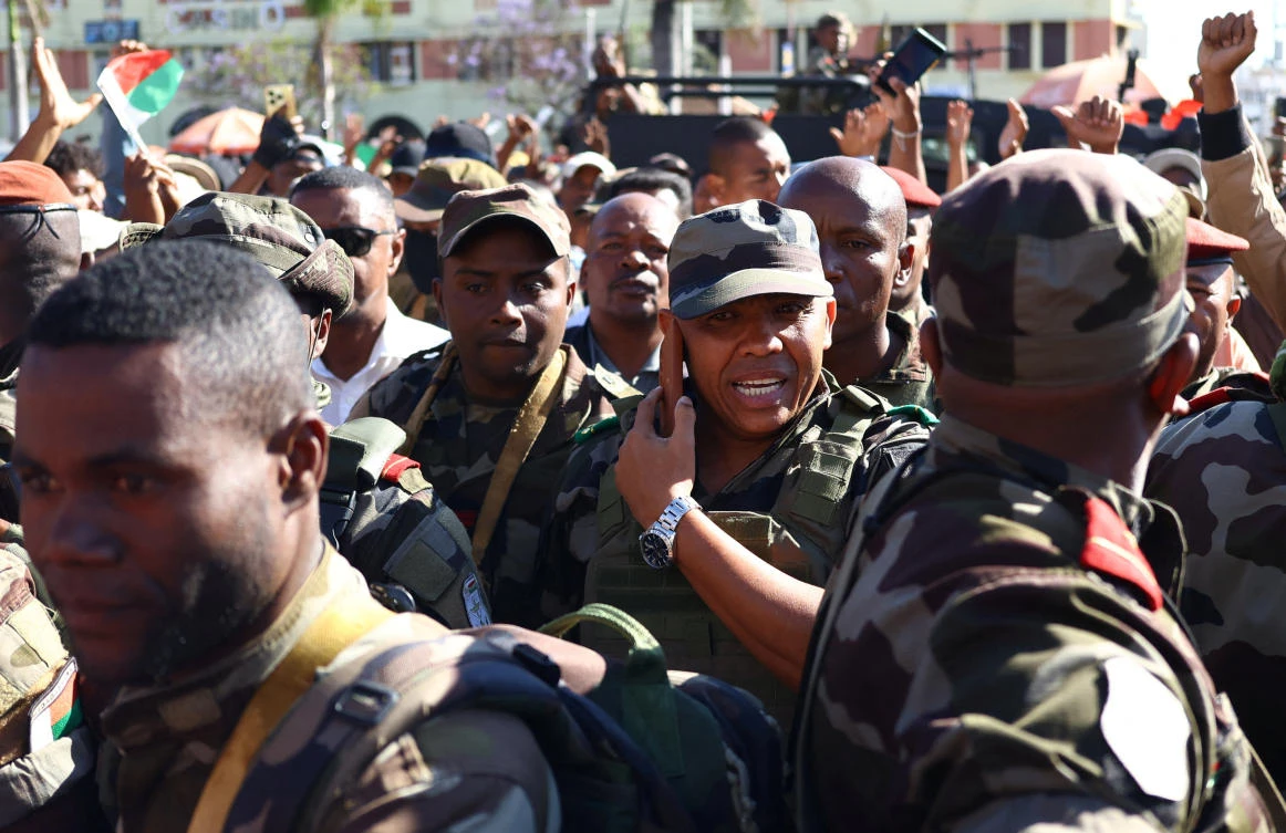 Col. Michael Randrianirina, head of the elite Madagascar military unit, center, arrives with military personnel to join protesters gathered in Antananarivo on Oct. 14, 2025. (Reuters)
