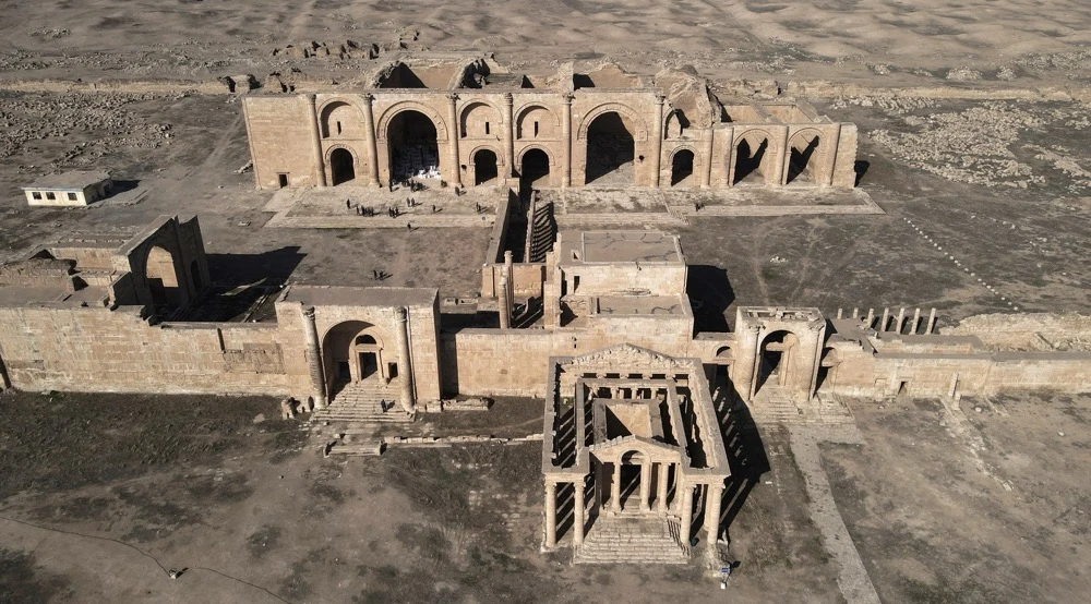 Western archaeologists and tourists swarmed the ancient sites of Mesopotamia in the early 20th century, inset, drawn to such heritage treasures as Hatra and the spiral Malwiya minaret of Samarra. (AFP)