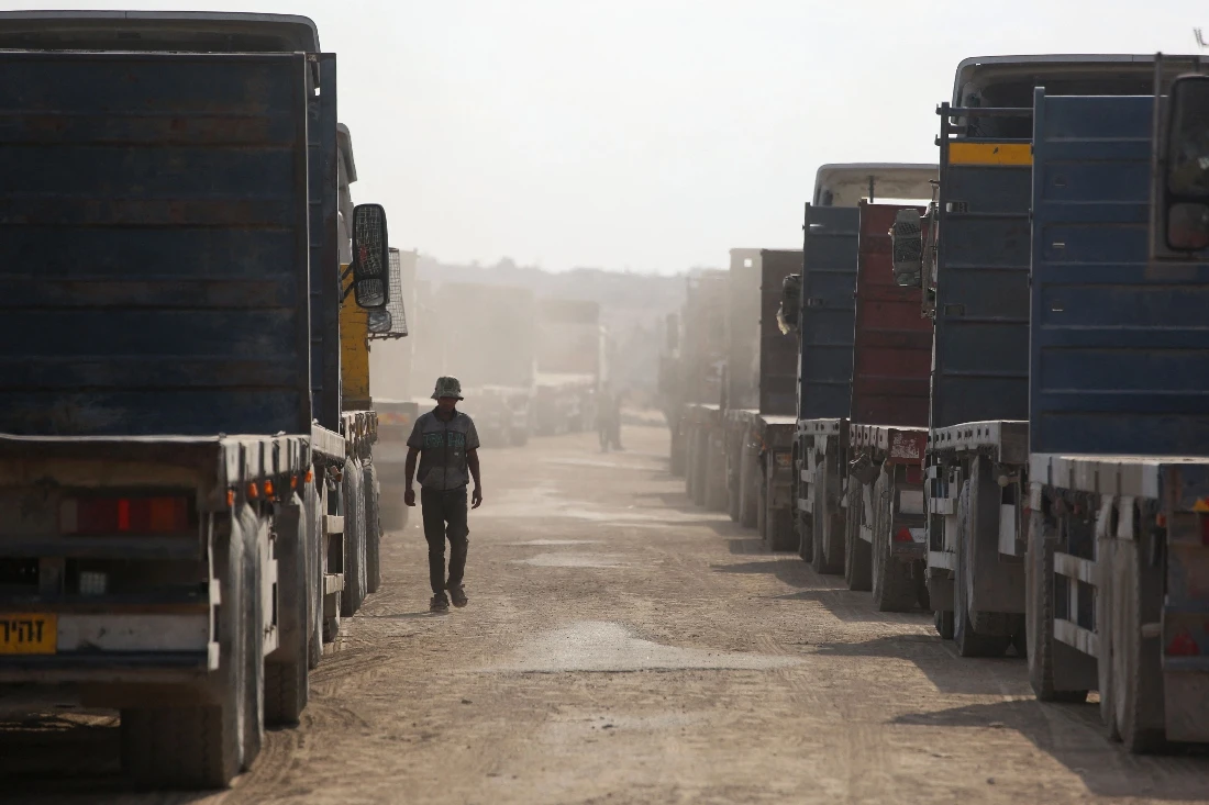 Trucks carrying aid provided by the World Food Programme (WFP) wait at the Kissufim crossing, located east of Deir el-Balah in the central Gaza Strip. (AFP)