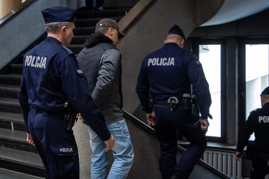 Police officers escort Ukrainian Volodymyr Z from the courtroom at Warsaw’s Regional Court after a hearing on his extradition to Germany as he is suspected of unconstitutional sabotage, destruction of property, and destruction of the Nord Stream 2 gas pipeline infrastructure, in Warsaw, on Oct. 17, 2025. (AFP)