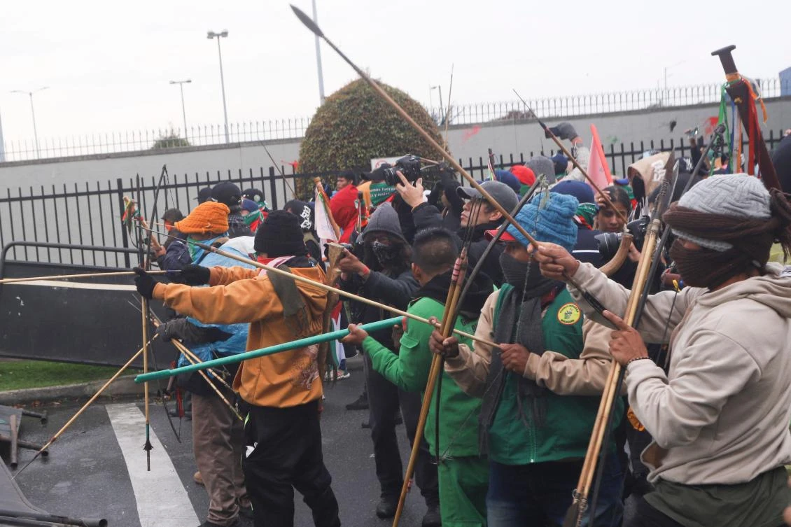 Demonstrators shoot arrows at police officers near the entrance of the US embassy during a protest in Bogota on Oct. 17, 2025. (AFP)