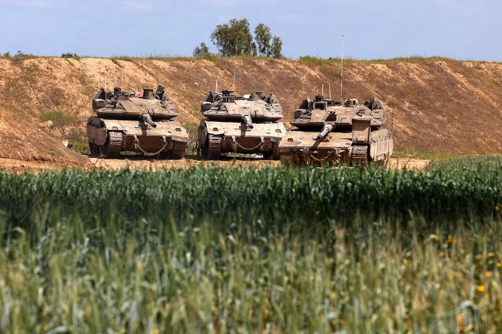 Above, Israeli military tanks are positioned along Israel’s southern border with the northern Gaza Strip. (AFP file photo)