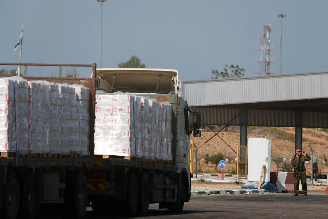 A truck carrying aid waits at the Israeli side of the Kerem Shalom border crossing to southern Gaza on Oct. 20, 2025. (Reuters)
