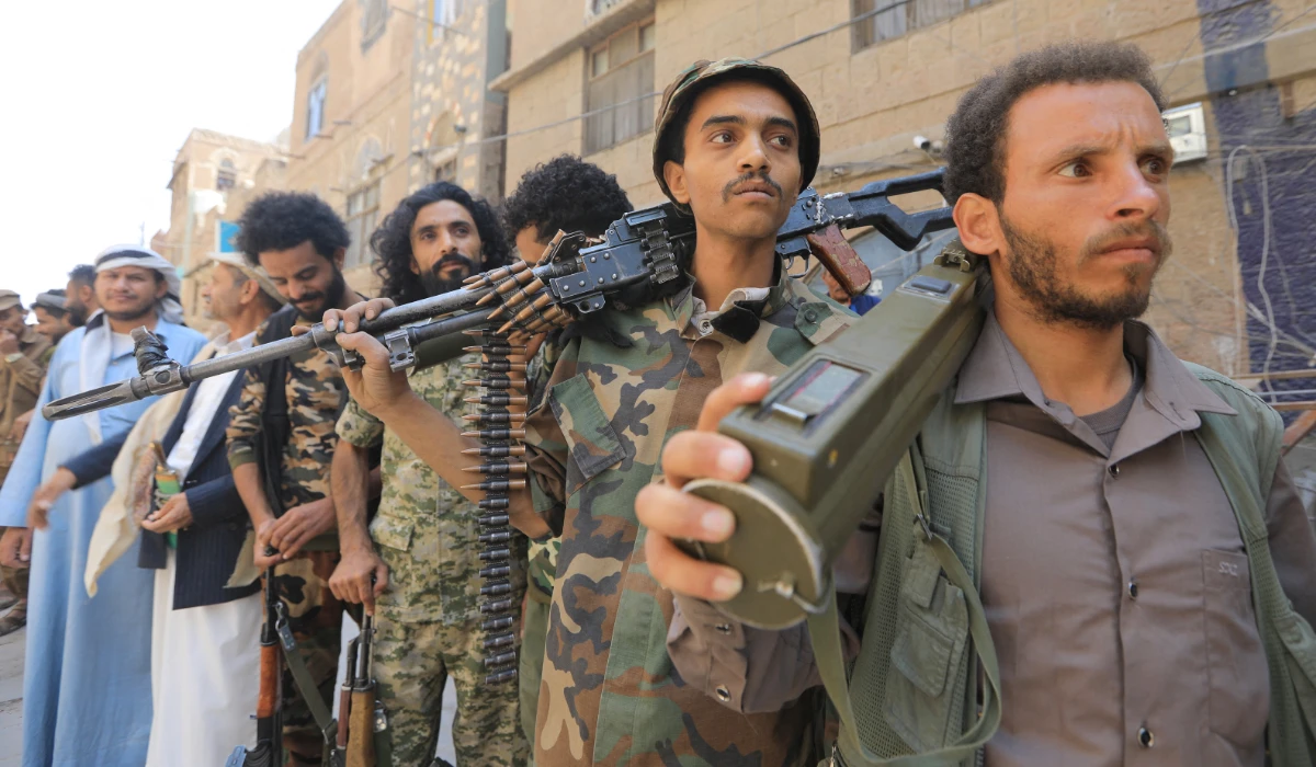 Houthi fighters attend a demonstration near the site of a recent Israeli airstrike, in the Houthi-controlled capital Sanaa on September 13, 2025. (AFP)