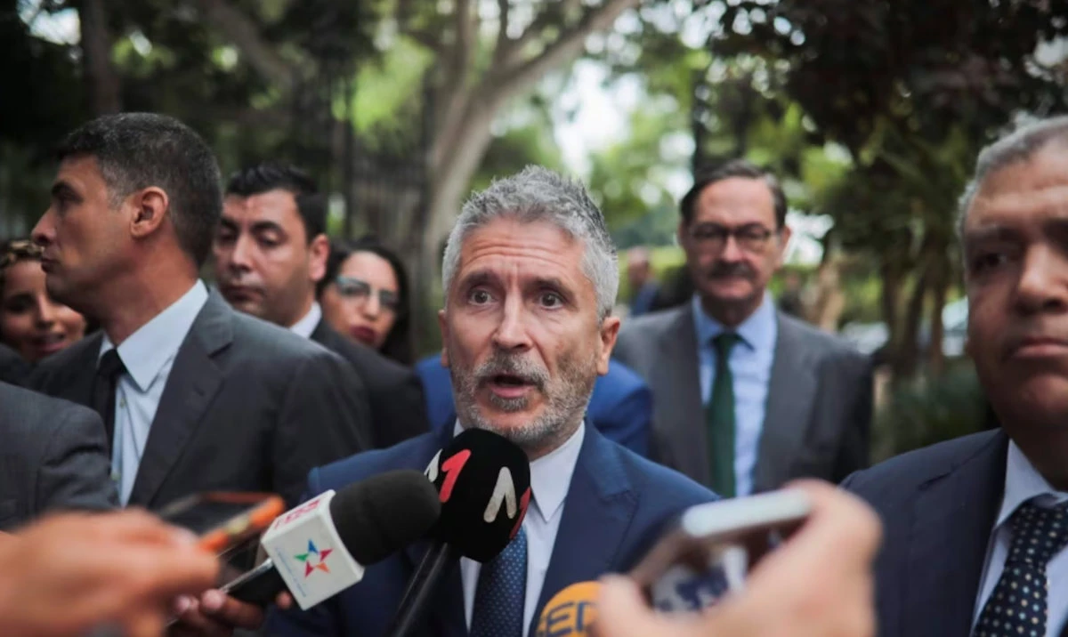 In this file photo, Spanish Interior Minister Fernando Grande-Marlaska, center, gives a statement to journalists. (AP)