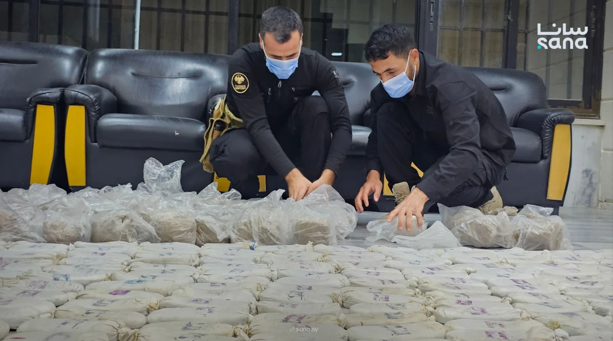 Members of the Syrian Anti-Narcotic Directorate demonstrate a drug shipment that was seized jointly with their Iraqi counterparts. (SANA)