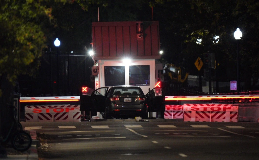 A man was taken into custody late Tuesday after driving his car into a security barrier outside the White House, authorities said. (X/@PenguinSix)