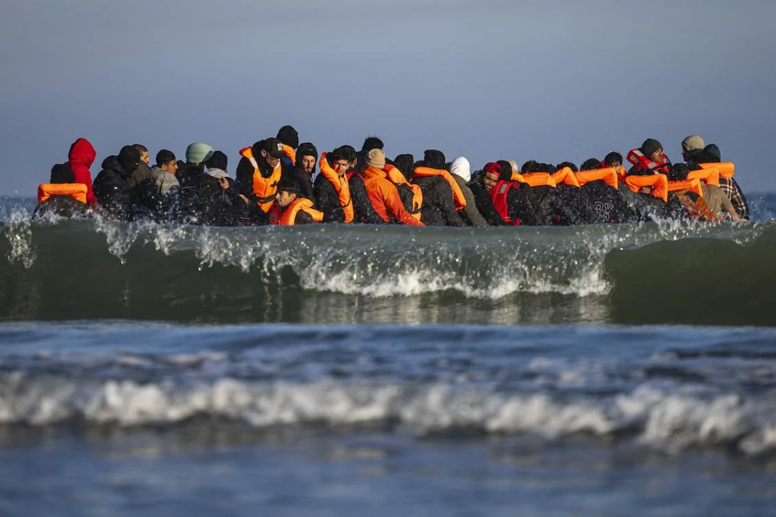 Migrants sit in a smugglers' boat in an attempt to cross the English Channel off the beach of Gravelines, northern France on September 27, 2025. (FILE/AFP)