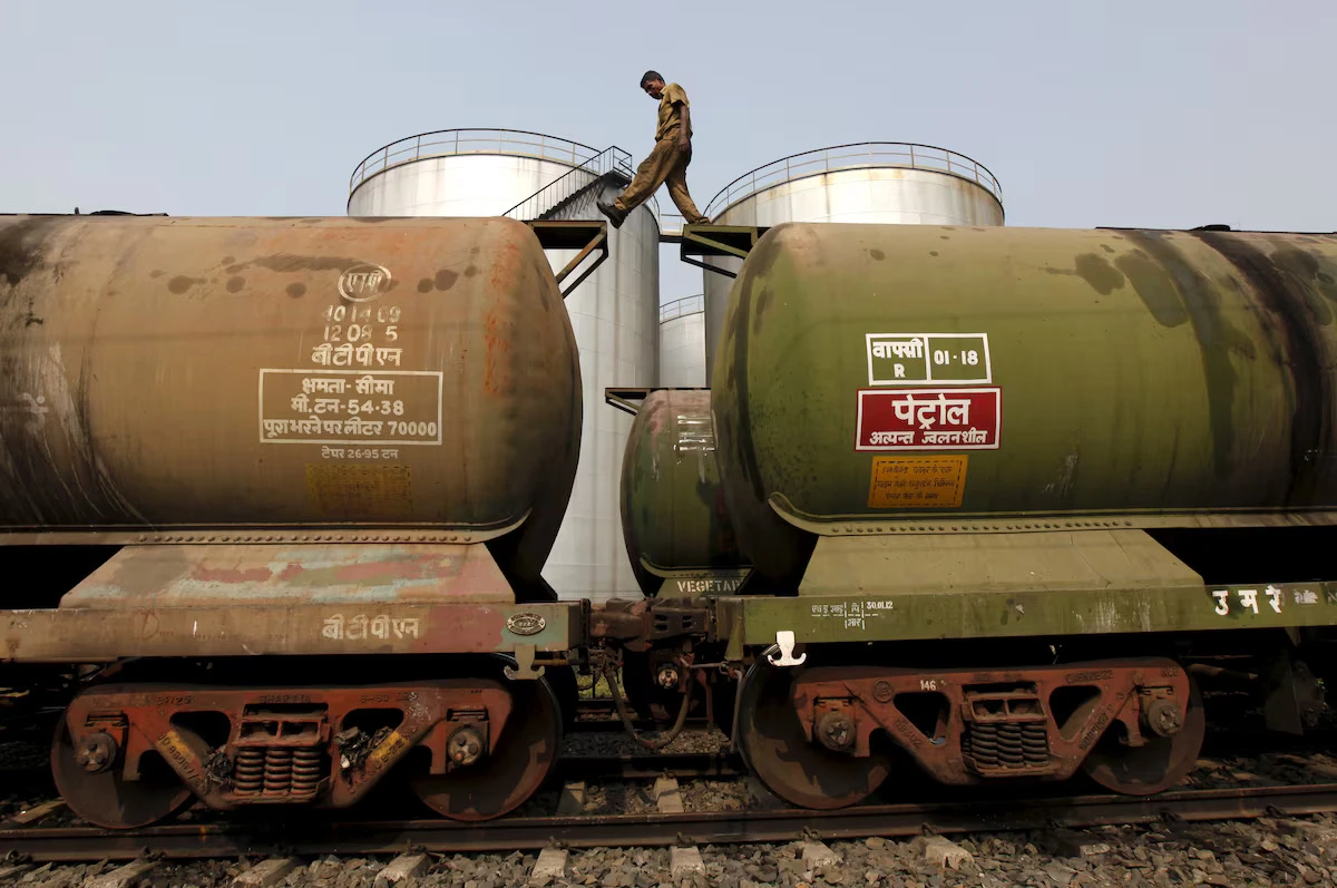 In this file photo, a worker walks atop a tanker wagon to check the freight level at an oil terminal on the outskirts of Kolkata, India on Nov. 27, 2013. (Reuters)