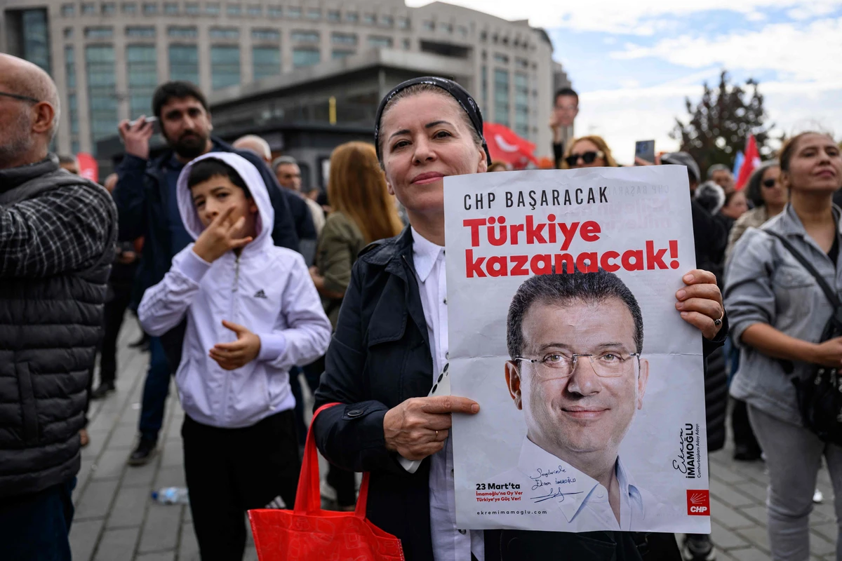A protester holds a poster with the picture of jailed Istanbul Mayor Ekrem Imamoglu during a rally organized by the country’s main opposition party, the Republican People’s Party (CHP), to protest the suspension and imprisonment of Istanbul Mayor, in Istanbul, Oct. 26, 2025. (Yasin AKGUL / AFP)