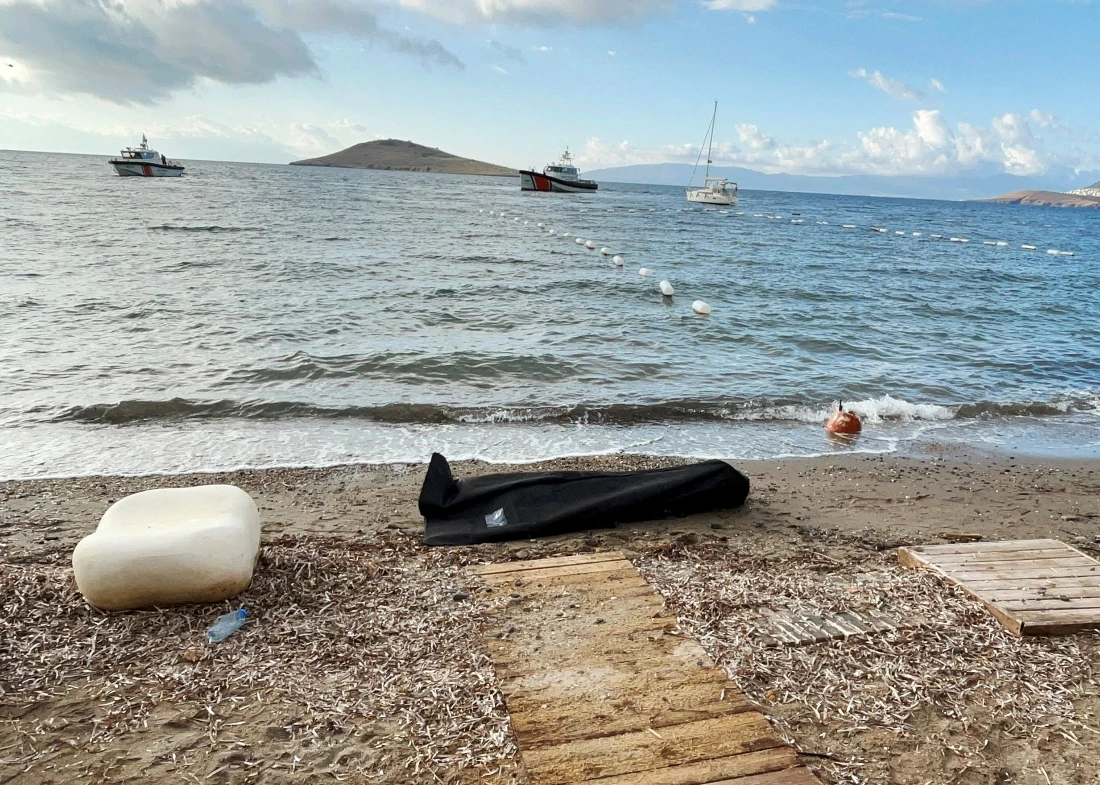 A body bag lies on the shore as Coast Guard Command members conduct a search and rescue operation following the sinking of a migrant boat off western Mugla province, Turkiye. (Reuters)