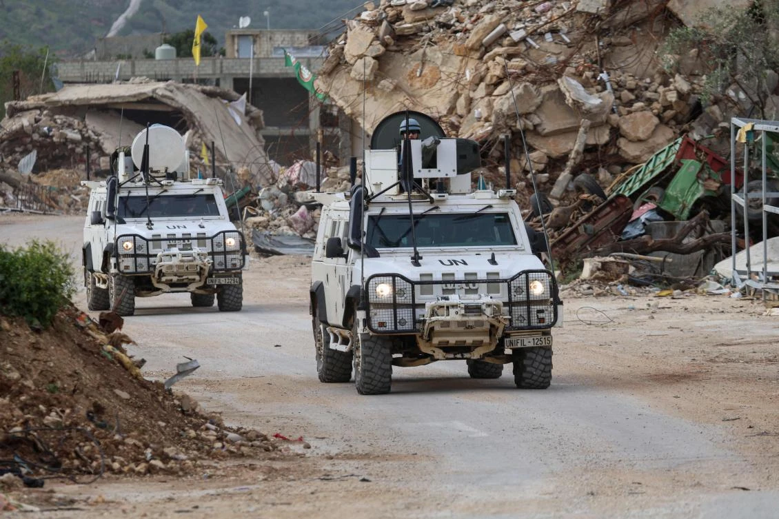 United Nations peacekeepers drive past destroyed buildings while patrolling in Lebanon’s southern village of Kfar Kila, close to the border with Israel, Apr. 6, 2025. (AFP)