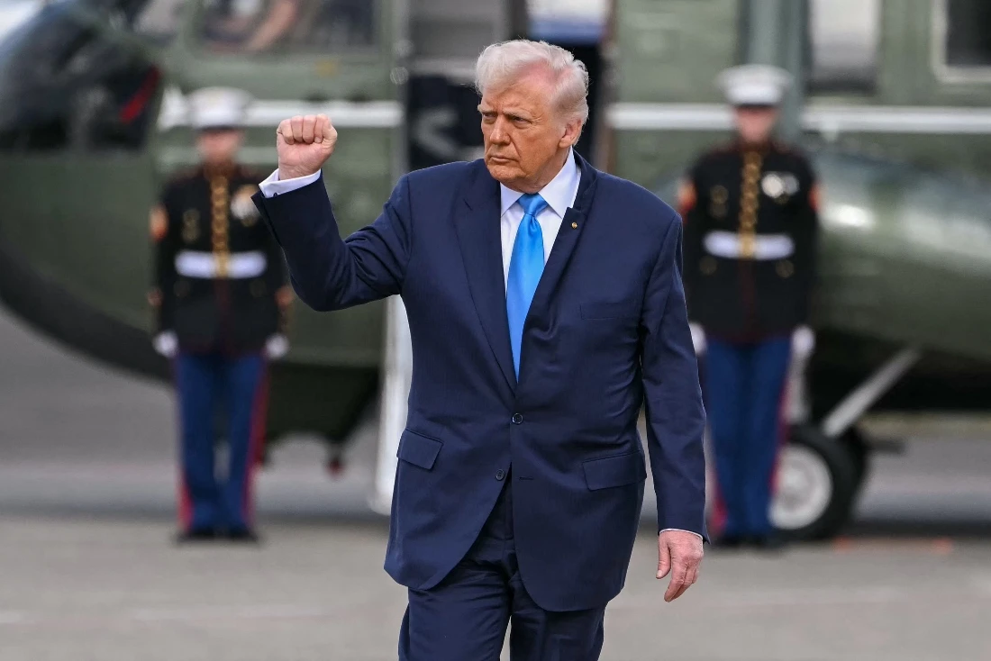 US President Donald Trump gestures before boarding Air Force One before travelling to South Korea, at Haneda Airport in Tokyo, Japan. (AFP)