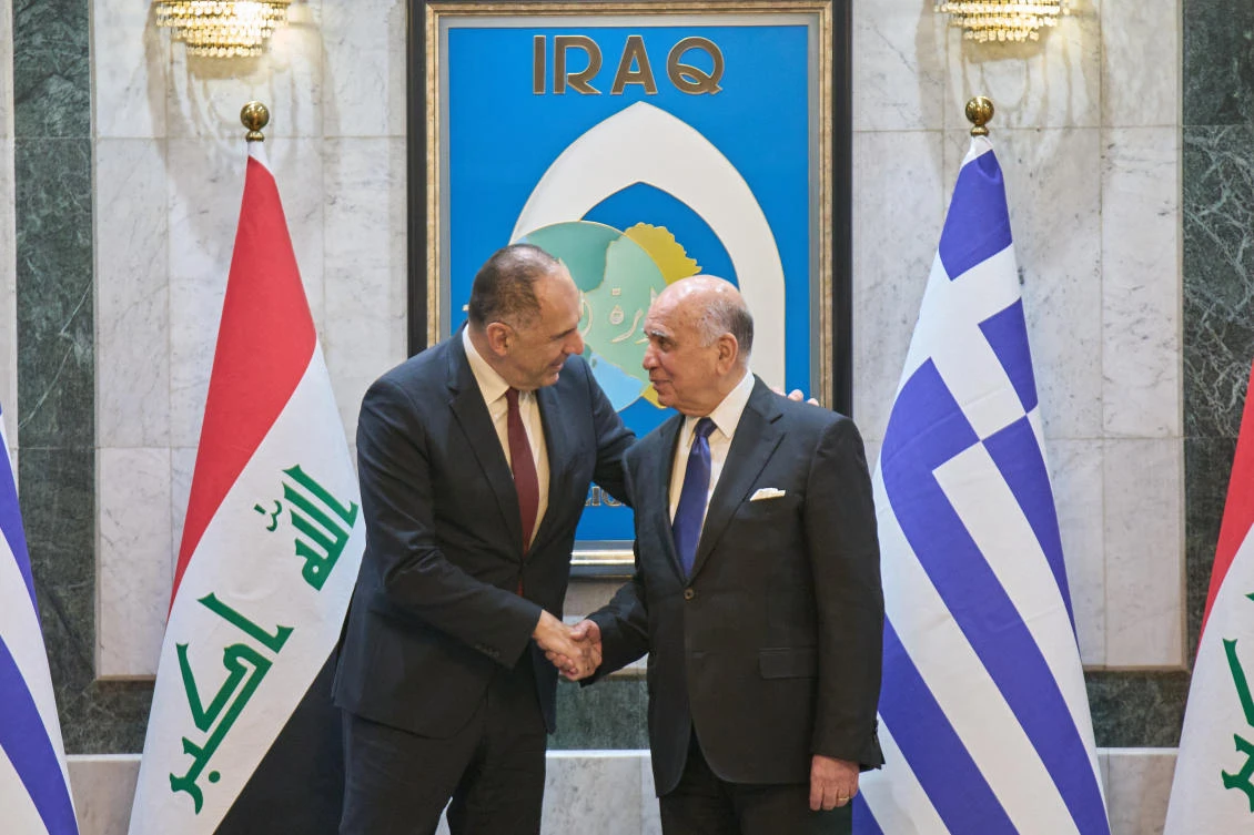 Iraqi Foreign Minister Fuad Hussein, right, shakes hands with his Greek counterpart George Gerapetritis, in Baghdad, Oct. 30, 2025. (AP)