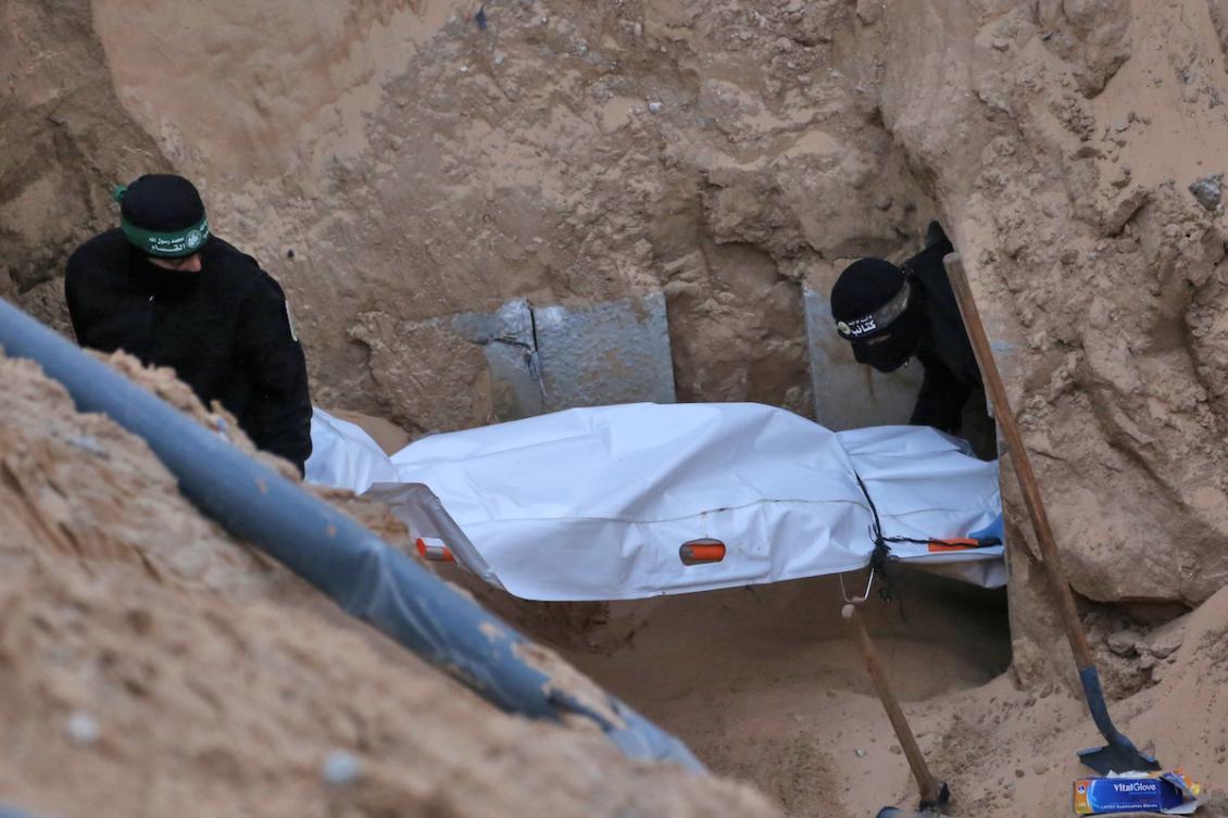 Hamas militants carry a body retrieved from a tunnel in an area north of Khan Yunis in the southern Gaza Strip on October 28, 2025. (FILE/AFP)
