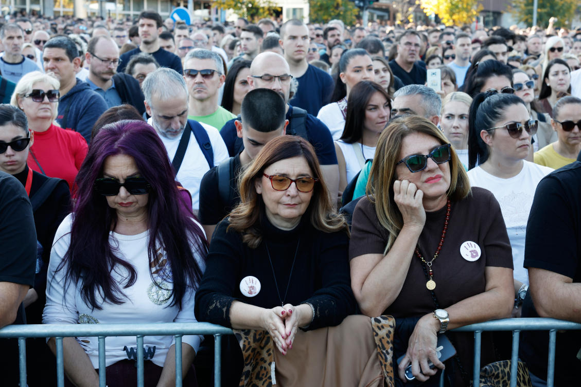 People observe 16 minutes of silence in memory of the victims, outside the train station, on the first anniversary of the disaster that killed 16 people, in Novi Sad, Nov. 1, 2025. (AP)