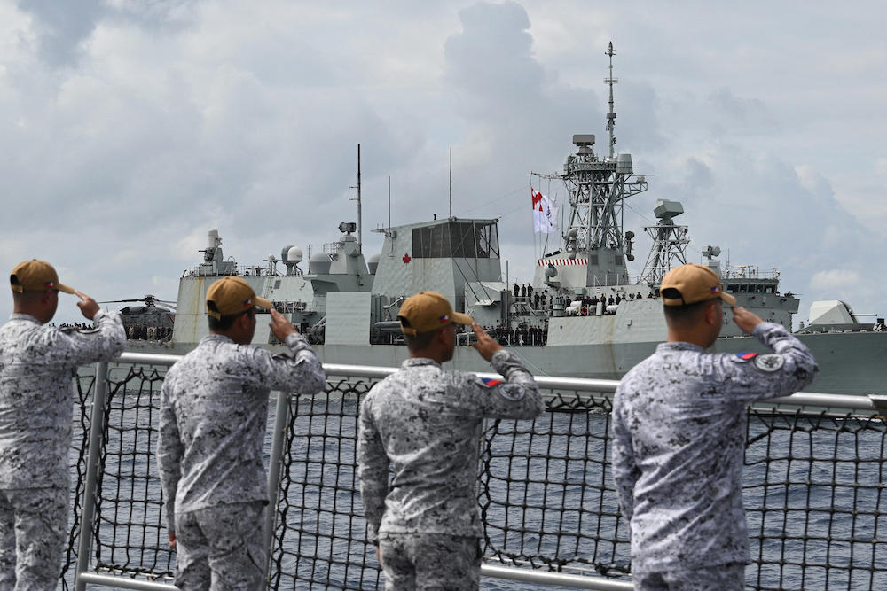 Sailors aboard the Philippine Navy frigate BRP Jose Rizal salute during a passing exercise with the Royal Canadian Navy frigate HMCS Ville de Quebec near Scarborough Shoal in disputed waters of the South China Sea on Sept. 3, 2025. (AFP)