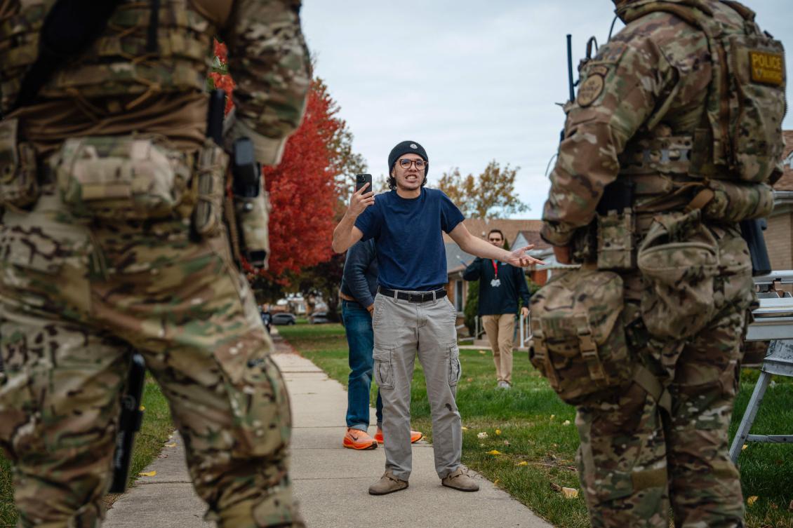 A young man confronts federal agents after they arrested a worker at a home in his Edison Park neighborhood on Oct. 31, 2025, in Chicago, Illinois. (Getty Images/AFP)