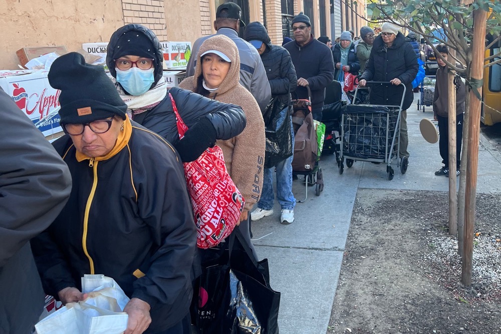 People wait in line for free food at the World of Life Christian Fellowship International food pantry in the Bronx borough of New York. (AP)