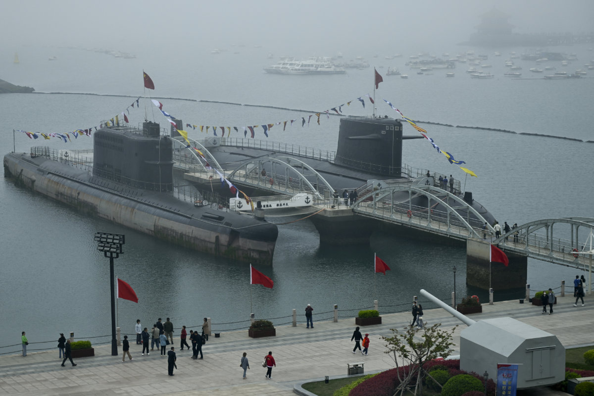 This picture taken during a media tour organized by the Chinese People's Liberation Army Navy to mark its 75th founding anniversary, shows two submarines at the PLA Naval Museum in Qingdao, China's Shandong province on April 23, 2024. (AFP)