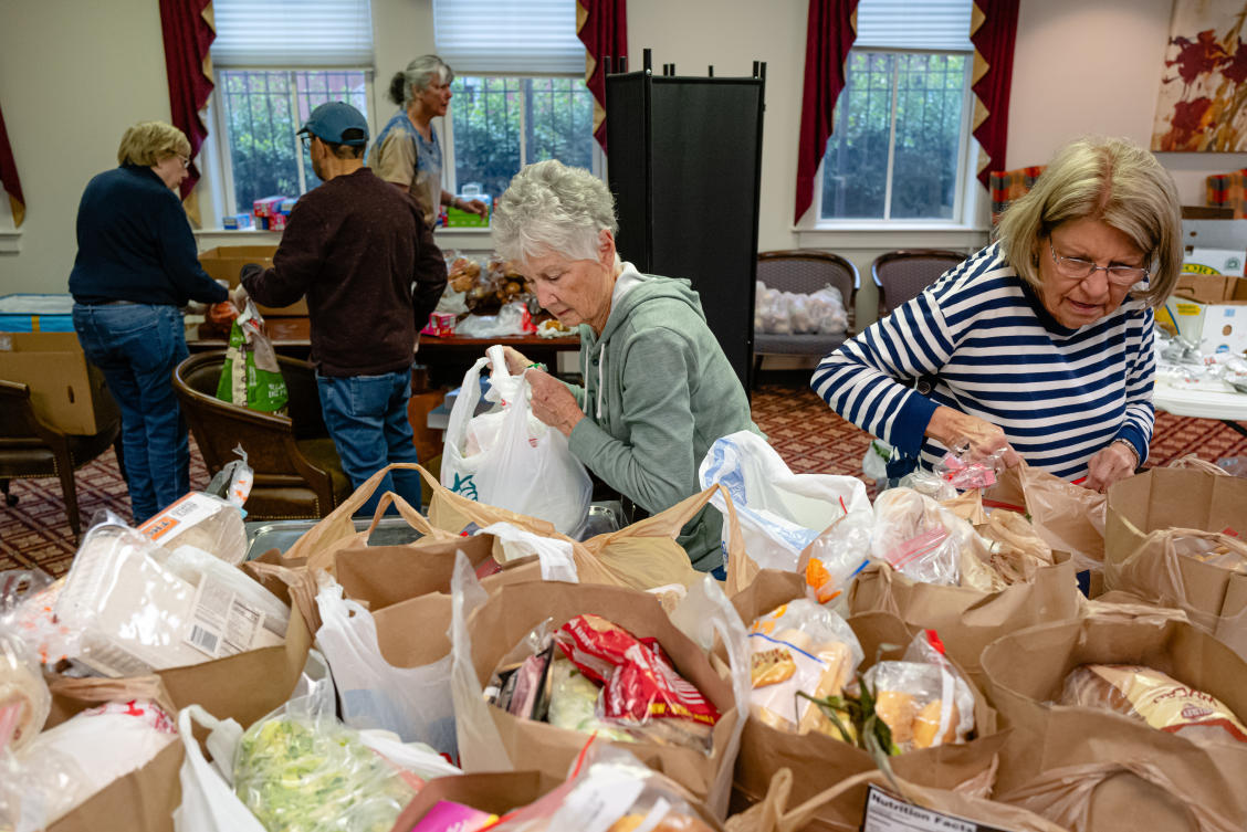 Above, volunteers work to package meals during the food pantry service at Calvary Episcopal Church in Louisville, Kentucky. Advocates and beneficiaries say halting the the nation’s biggest food aid program would force people to choose between buying groceries and paying other bills. (AP)
