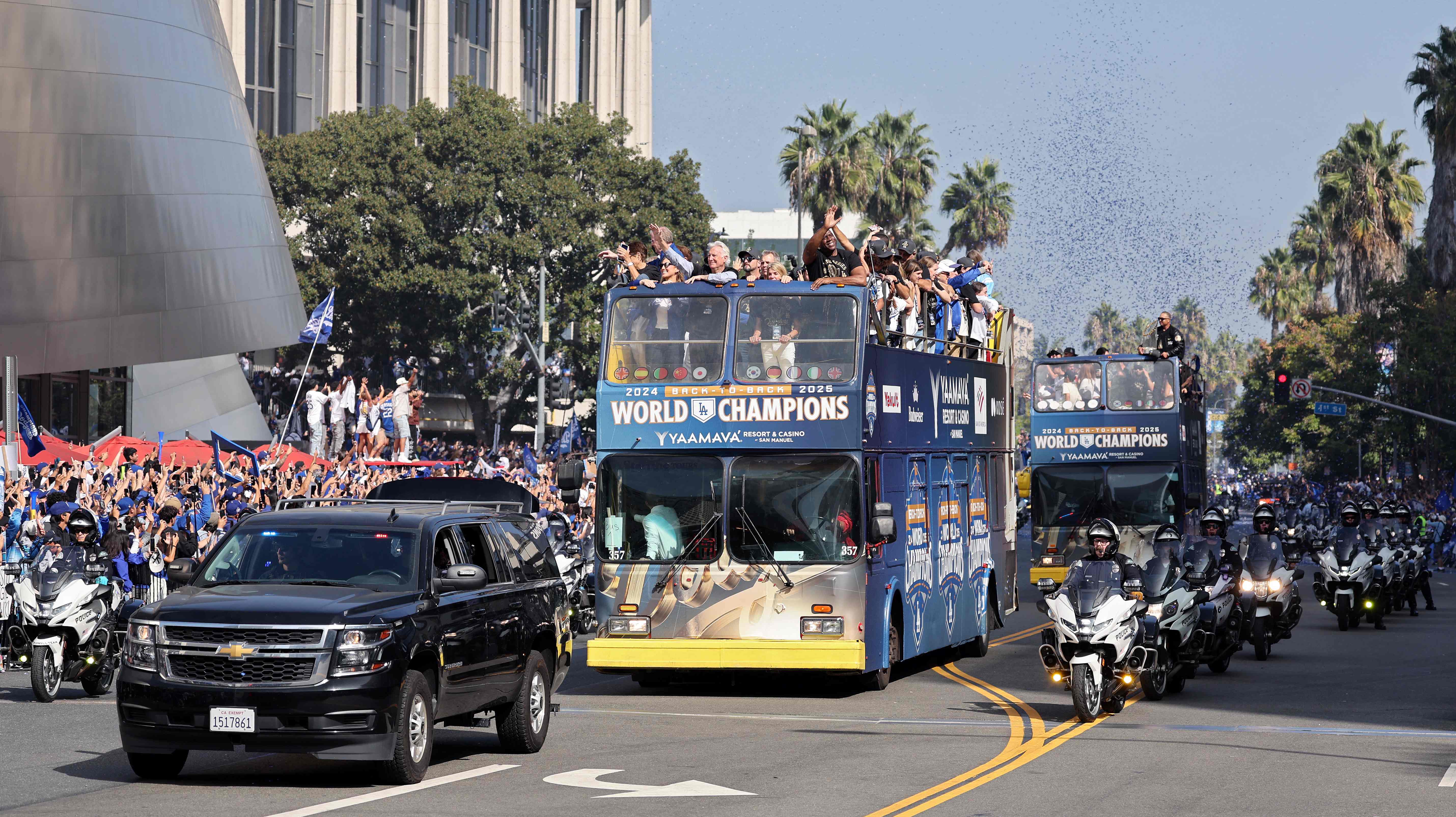 The Los Angeles Dodgers celebrate on buses during the Dodgers 2025 World Series Championship parade on Monday in Los Angeles, California. (Getty Images via AFP)