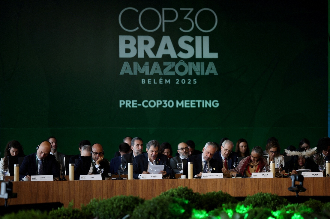 Brazil's Finance Minister Fernando Haddad speaks next to Simon Stiell, Executive Secretary of UN Climate Change (UNFCCC), and Brazil's COP30 President Andre Correa do Lago during the ministerial preparatory meeting (Pre-COP30), ahead of the COP30 Climate Summit, in Brasilia, Brazil. (Reuters)