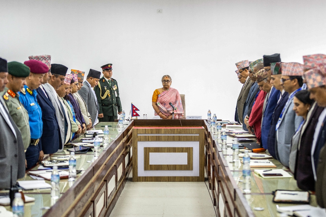 Newly elected Prime Minister of Nepal's interim government Sushila Karki (C), along with officials, observes a moment of silence to pay her tribute to those who lost their lives in recent protests in Kathmandu. (AFP)