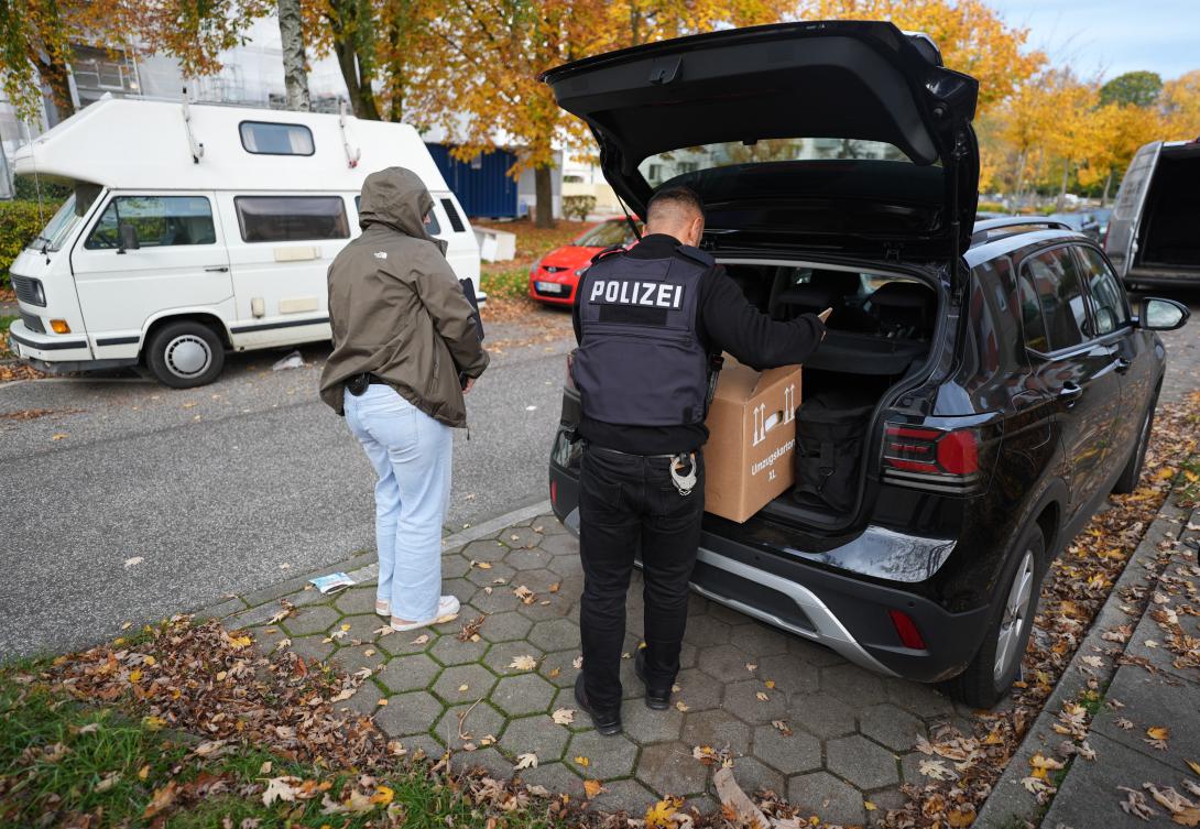 German police officers carry seized material from an apartment after a raid in Hamburg on Nov. 5, 2025. (dpa via AP)