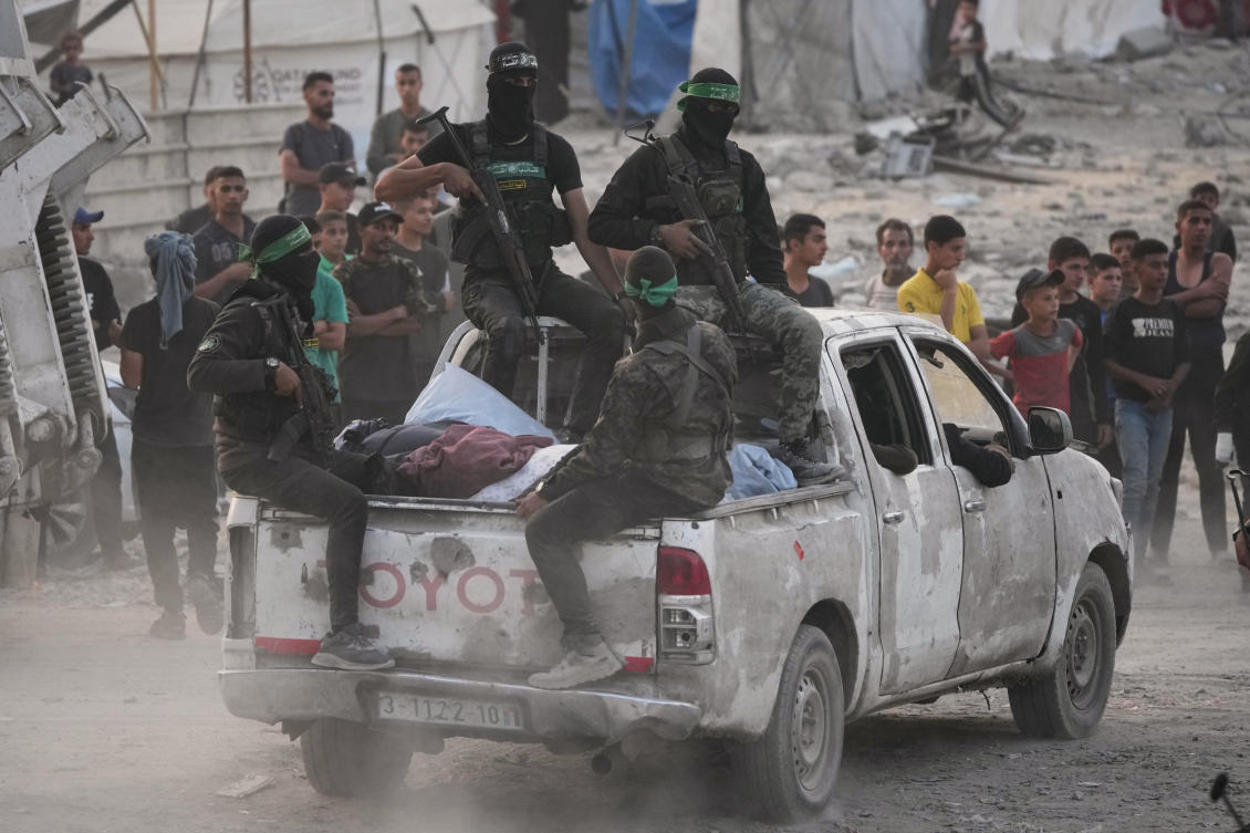 Hamas militants search for the bodies of Israeli hostages in the Shijaiyah neighborhood of Gaza City Wednesday, Nov. 5, 2025. (AP)