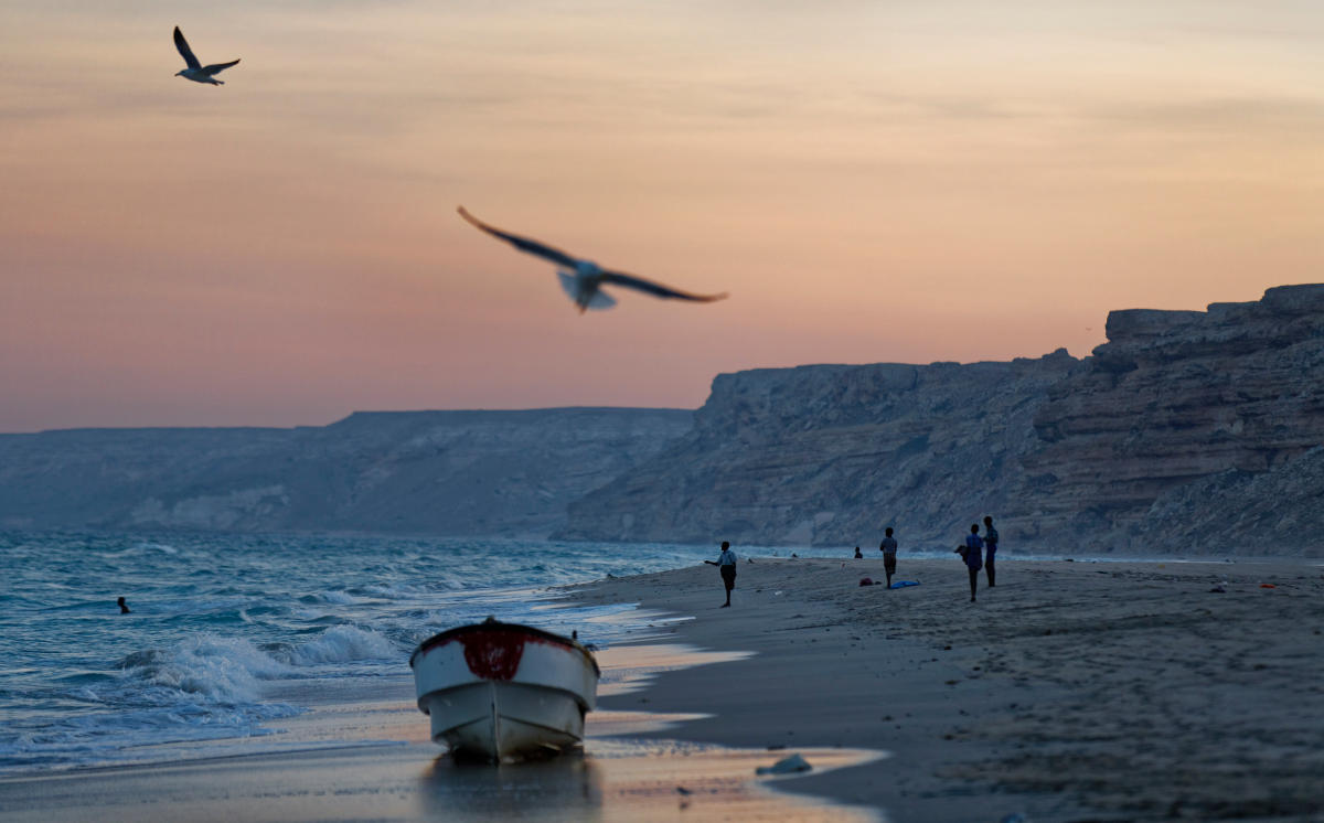 Fishermen stand on an Indian Ocean beach at dusk near the former pirate village of Eyl, in Somalia’s semi-autonomous northeastern state of Puntland, Somalia, Mar. 6, 2017. (AP Photo)