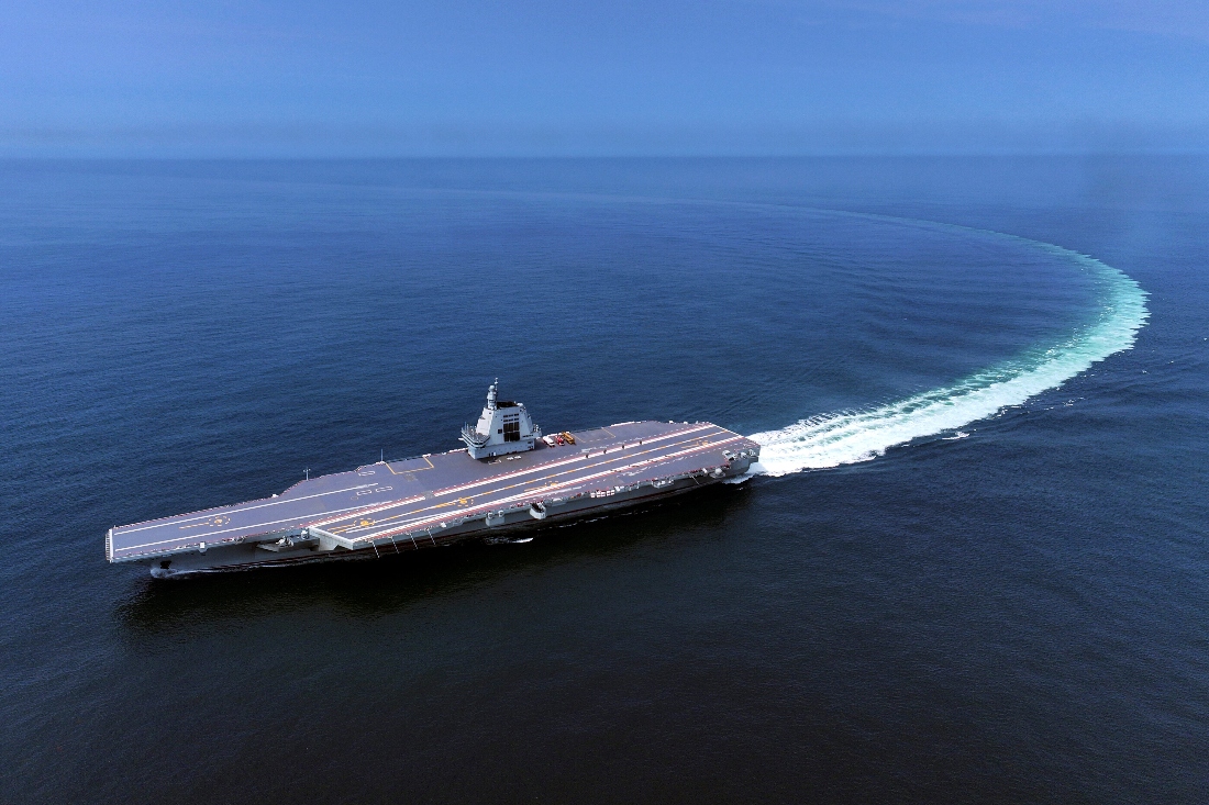 In this photo released by Xinhua News Agency, China's third conventionally powered aircraft carrier, the Fujian, conducts a maiden sea trial.