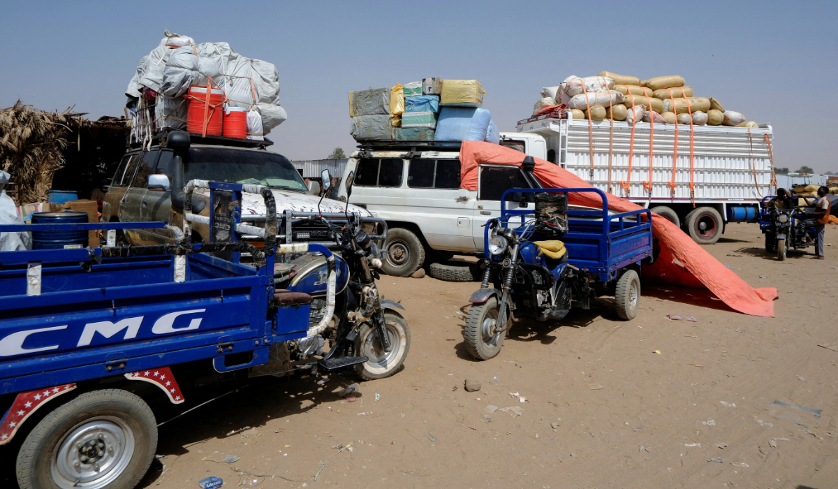 Trucks transport displaced people from El-Fasher. (Reuters)