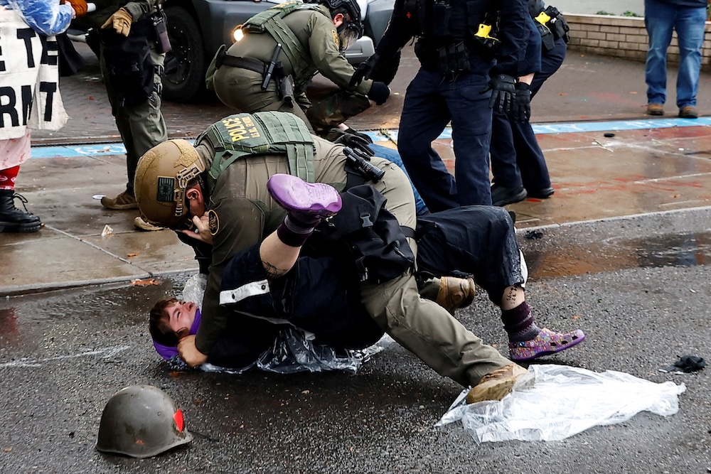 A federal officer detains a protester during a protest against increased activity by US Immigration and Customs Enforcement and potential National Guard deployment in Portland, Oregon on Oct. 12, 2025. (Reuters)