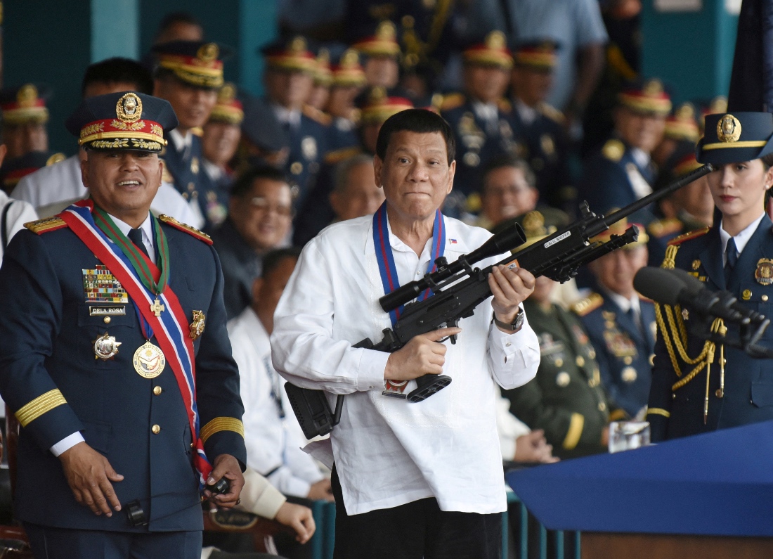 Philippine President Rodrigo Duterte holds a Galil sniper rifle next to outgoing Philippine National Police Chief Ronald Bato Dela Rosa during the National Police chief handover ceremony in Camp Crame. (Reuters)