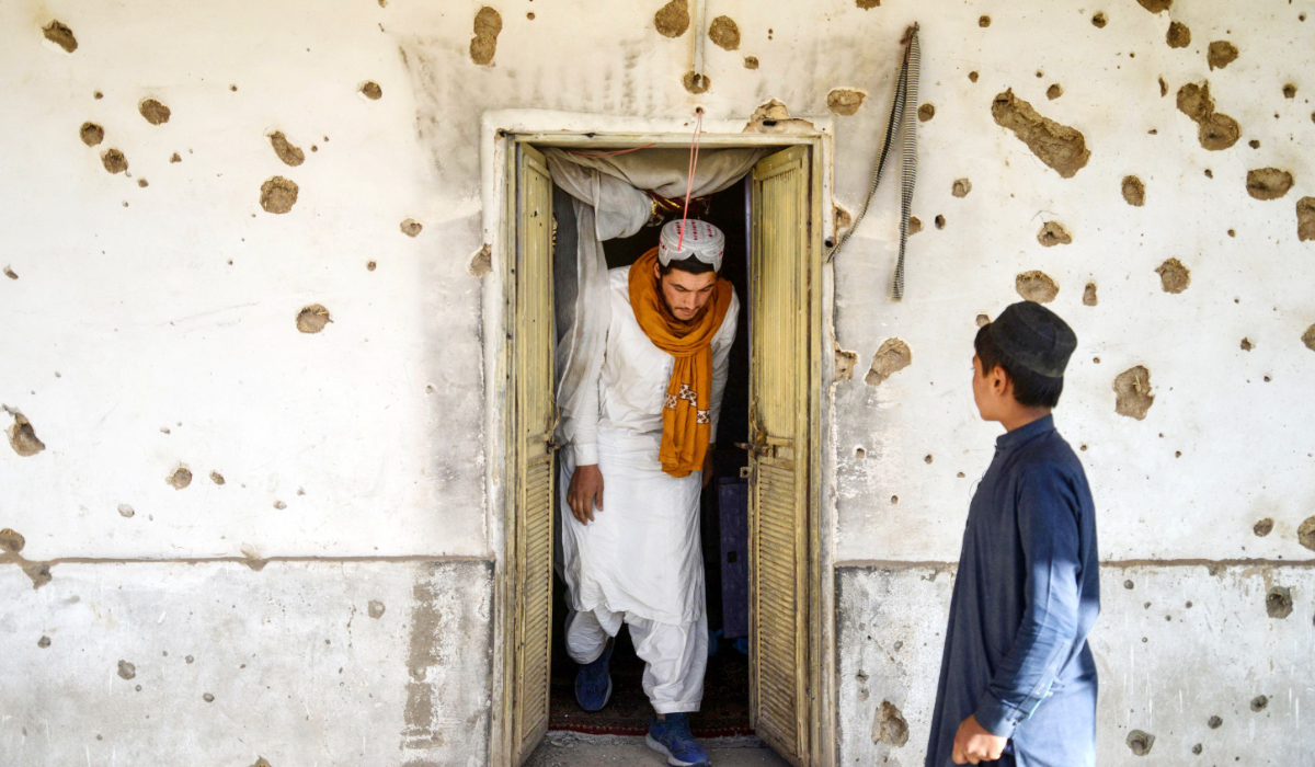 An Afghan man inspects a damaged house, following cross-border fire from Pakistan's artillery shelling, at a village in the Spin Boldak district of Kandahar on November 7, 2025. (AFP)