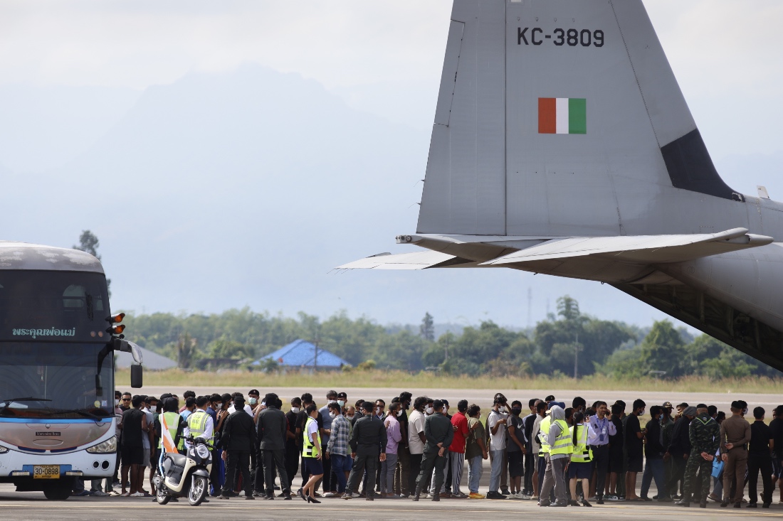 India nationals, believed to have worked at scam center in Myanmar, board a plane at Thailand's Mae Sot International Airport in Tak, before being sent back to India. (AP)